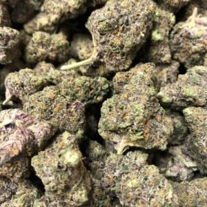 Close-up of Green Crack THCa Flower featuring vibrant green buds with orange pistils and frosty trichomes.