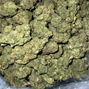 Sweet Banana THCa Flower buds with green hues, orange pistils, and a frosty trichome coating.
