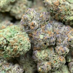 Chocolate Thai THCa Flower buds with dark green hues, light pistils, and a frosty coating of trichomes.